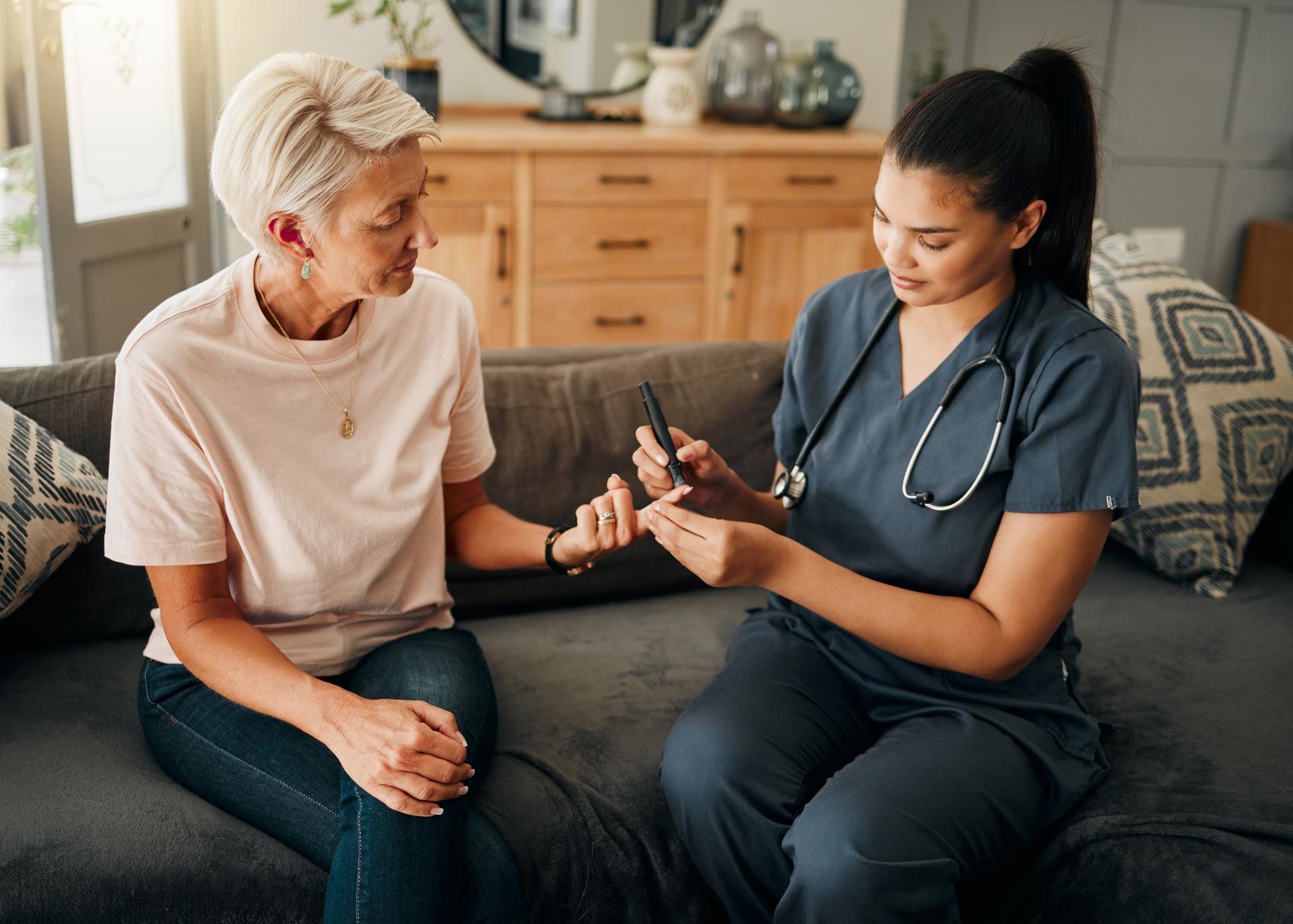 Diabetes, healthcare nurse and elderly woman finger doing blood test, sugar or medical test with a glucometer. Insurance doctor, health or diabetic senior lady consulting her glucose wellness at home